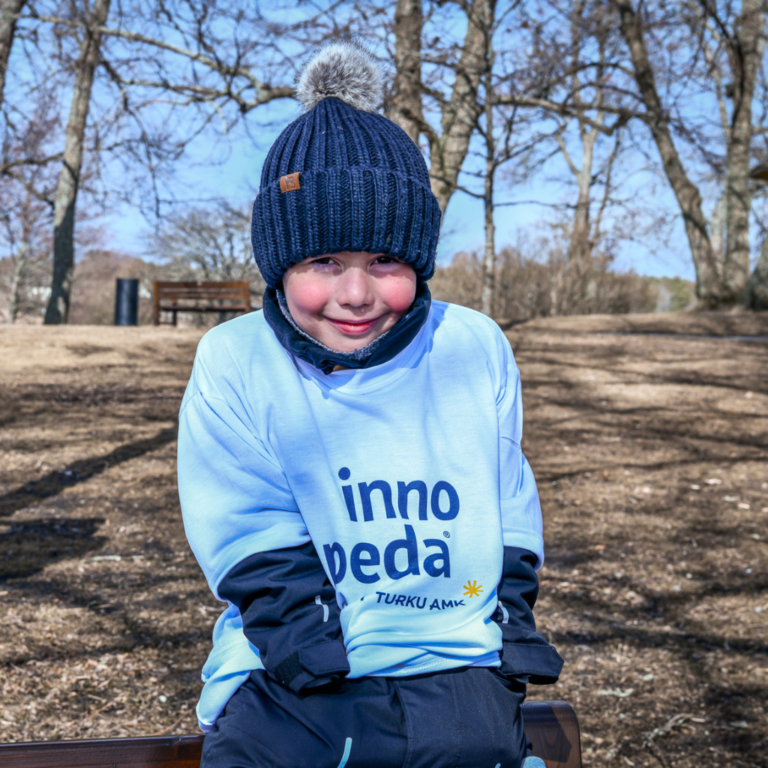 Kid sitting on a bench